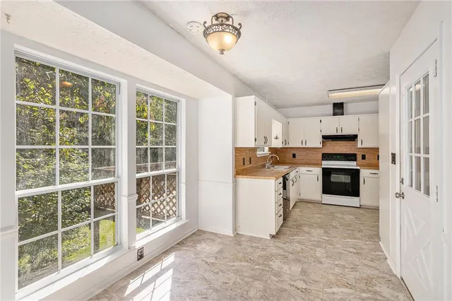 a kitchen with a refrigerator and a stove
