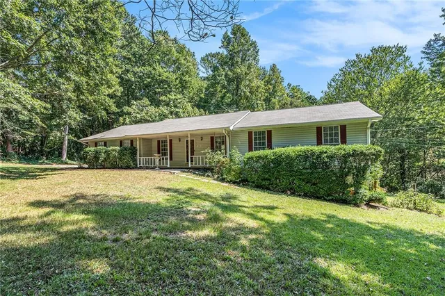 a front view of house with yard and green space