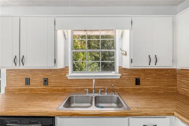 a kitchen with granite countertop a sink and a window