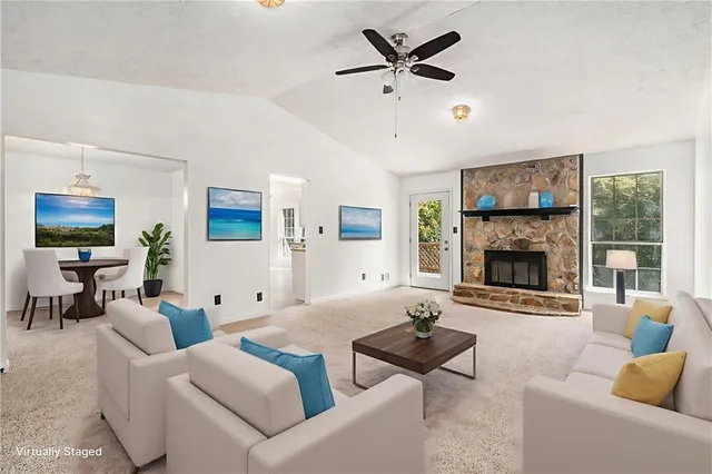 a living room with furniture a fireplace and a flat screen tv