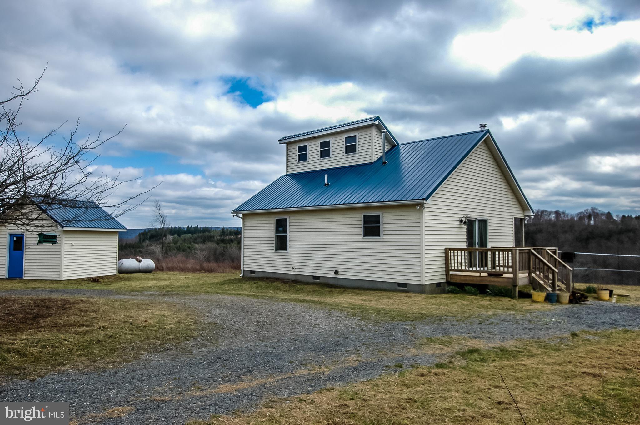 Rear view of house with a circular driveway