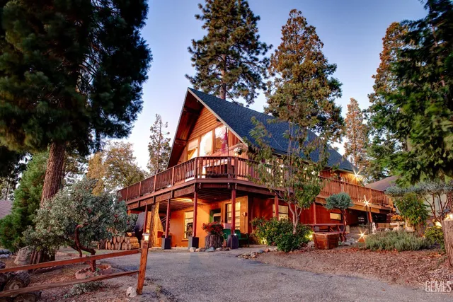 a front view of a house with a tree