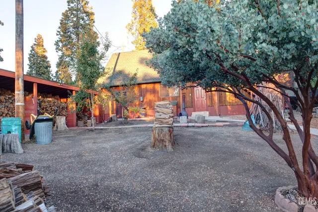 a view of a house with a yard and sitting area
