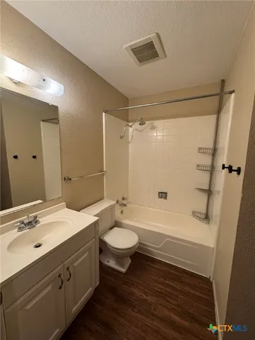 a bathroom with a double vanity sink toilet a mirror and shower