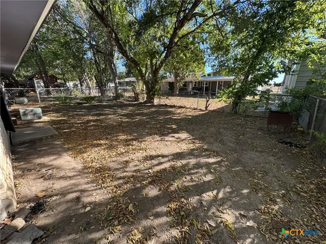 a view of a tree in the middle of a yard