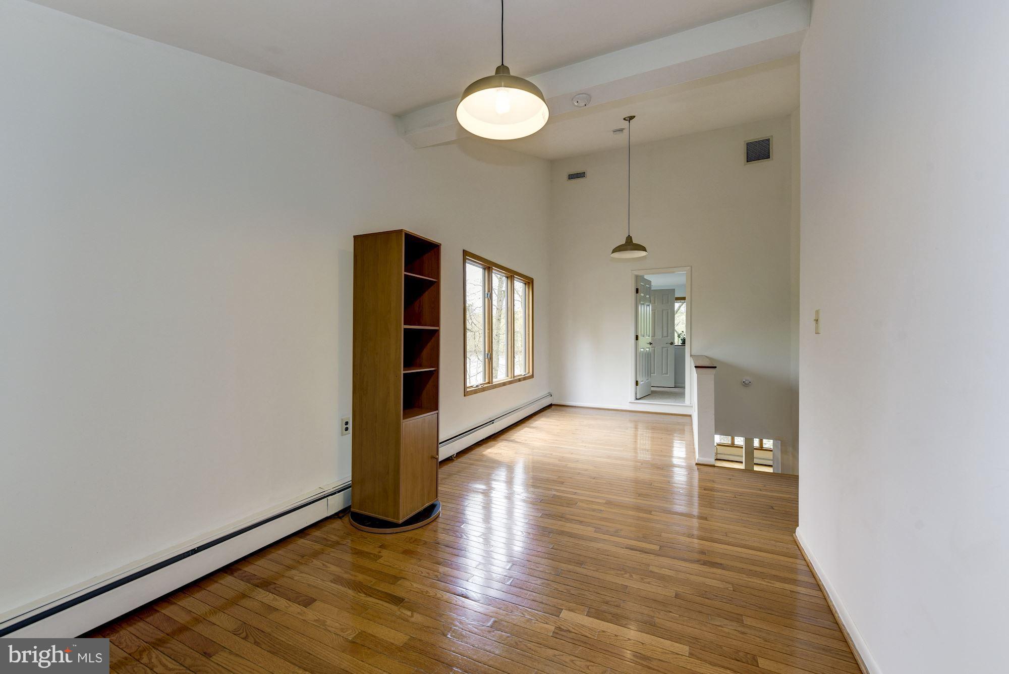 8 Robinson Road Medford, NJ 08055 - Photo 39 of 55 a view of an empty room with window and wooden floor