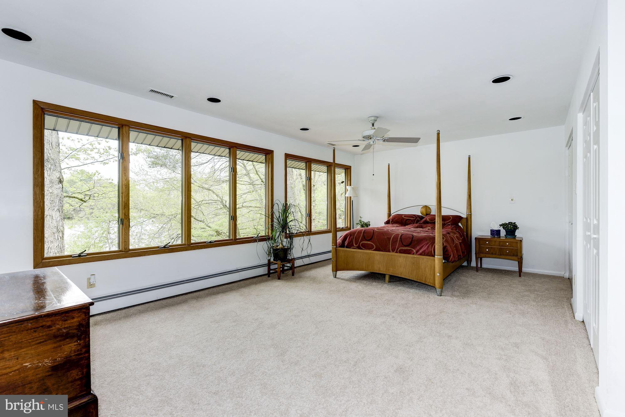 8 Robinson Road Medford, NJ 08055 - Photo 41 of 55 a spacious bedroom with a bed and a large window