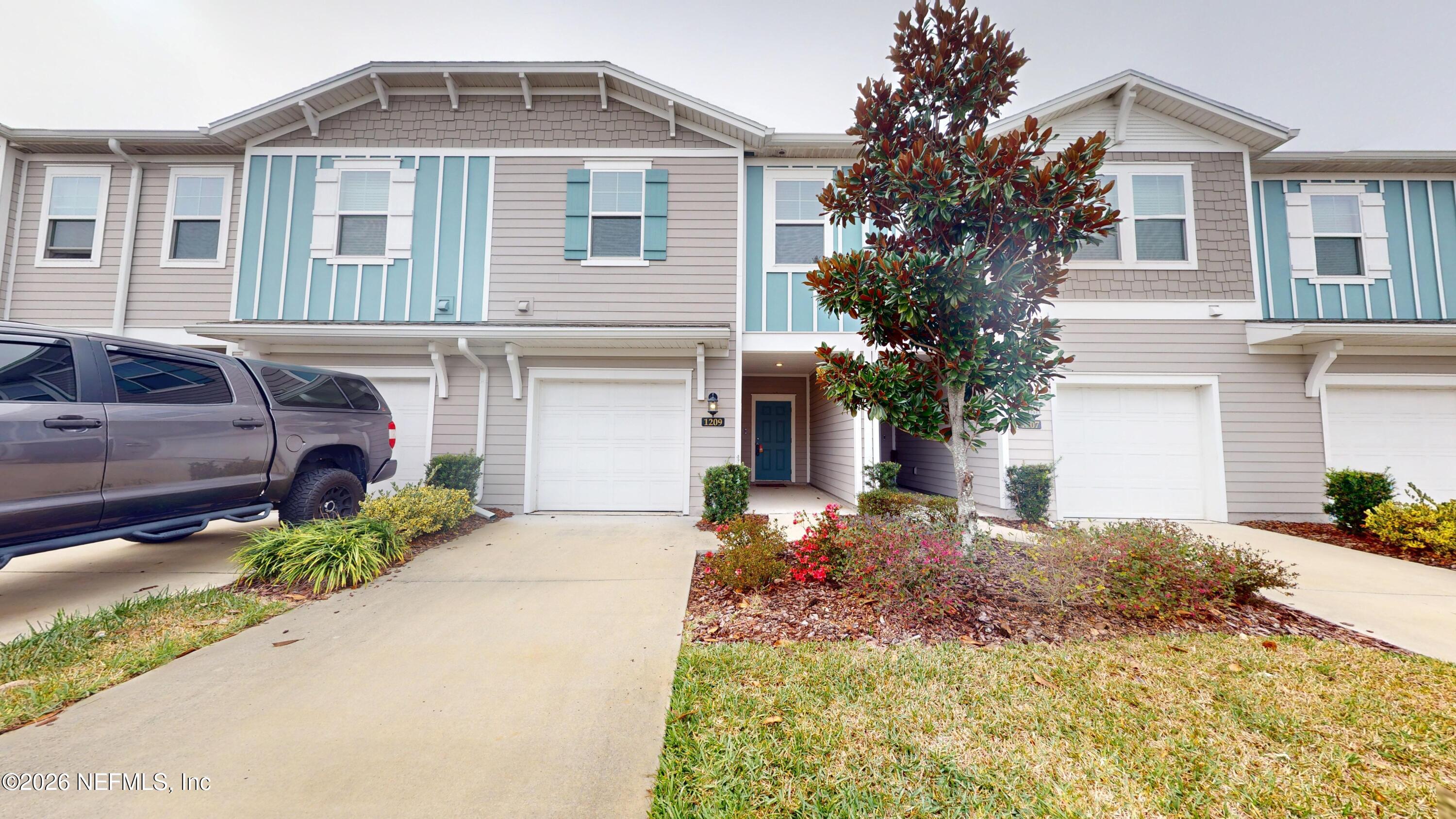 a front view of a house with a yard and garage