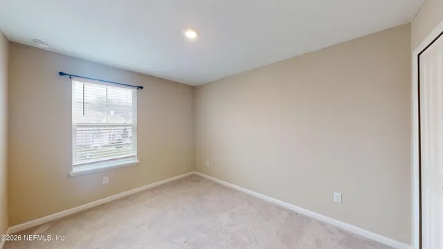 an empty room with windows and closet