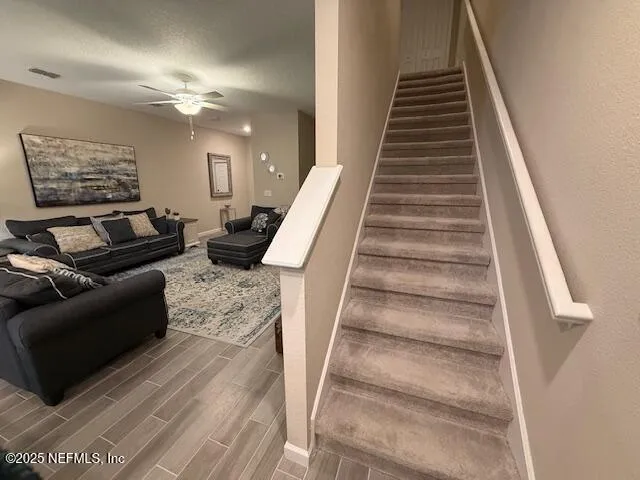 a view of entryway and hall with wooden floor