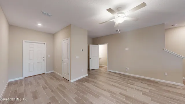 an empty room with fan and a ceiling fan