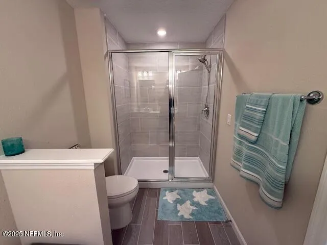 a bathroom with a shower a toilet and a sink