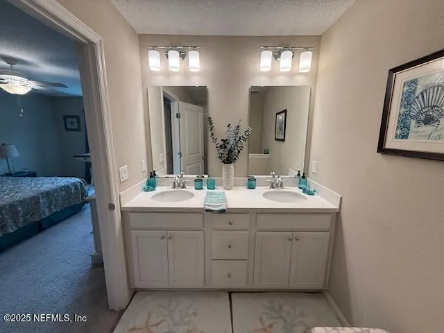a spacious bathroom with a double vanity sink and a mirror