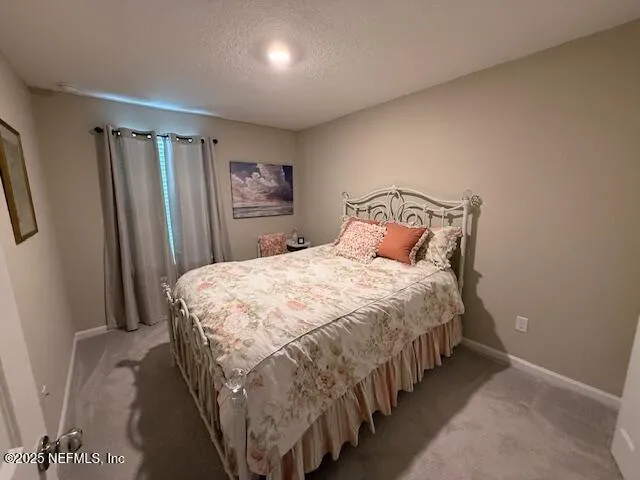 a bedroom with a bed and a mirror