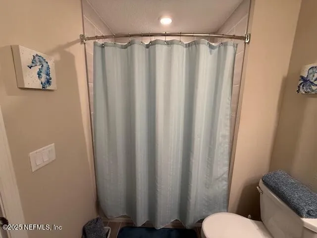 a bathroom with a shower curtain and a curtain