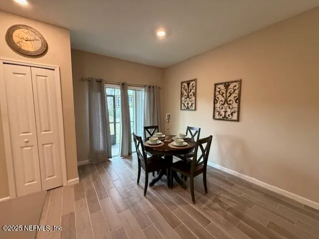a view of a dining room with furniture and wooden floor