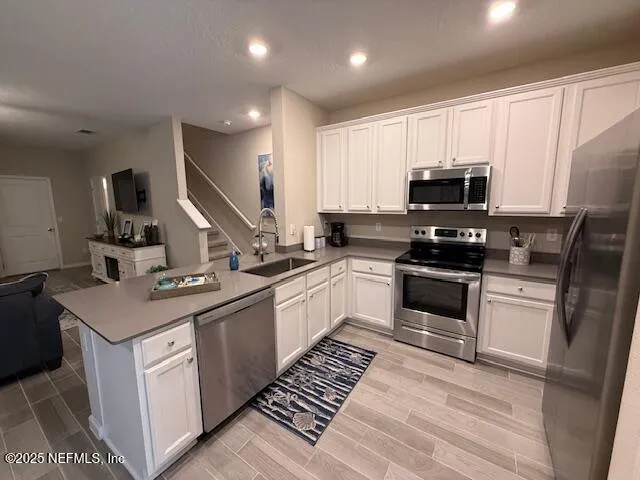 a kitchen with a sink stove and refrigerator