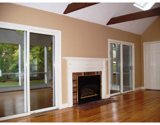 6 Partridge Way Canton, MA 02021 - Photo 11 of 25 a view of an empty room with wooden floor and a fireplace