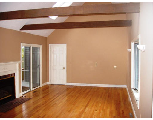 6 Partridge Way Canton, MA 02021 - Photo 12 of 25 a view of an empty room with wooden floor and a fireplace