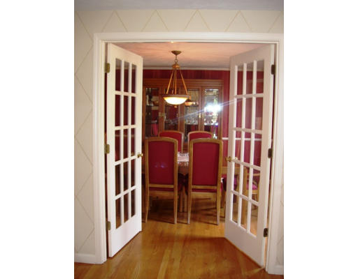 6 Partridge Way Canton, MA 02021 - Photo 6 of 25 a view of a hallway with dining room and wooden floor