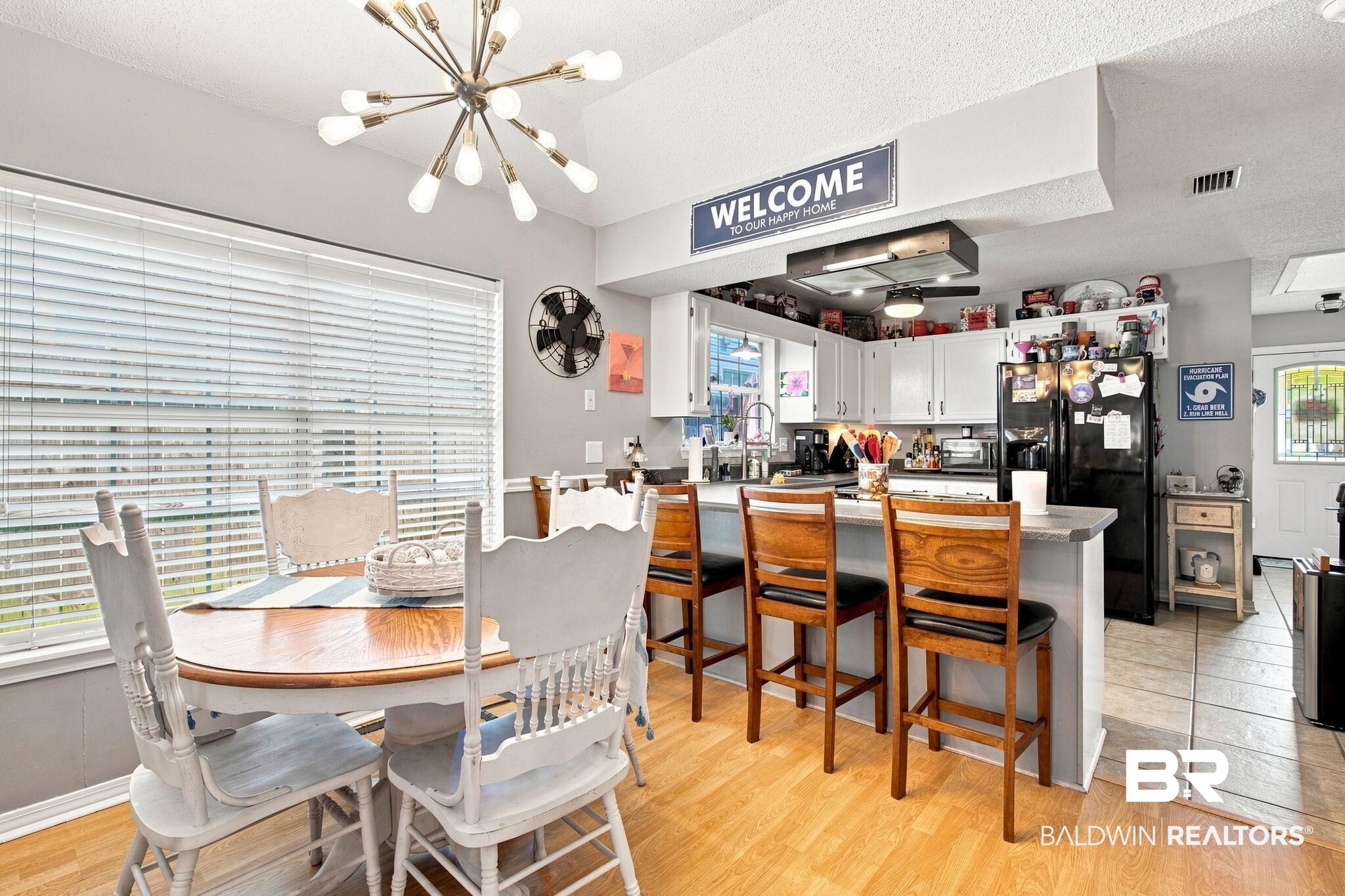 7577 Audubon Drive Foley, AL 36535 - Photo 12 of 33 Dining area with wood-finish flooring and a contemporary chandelier