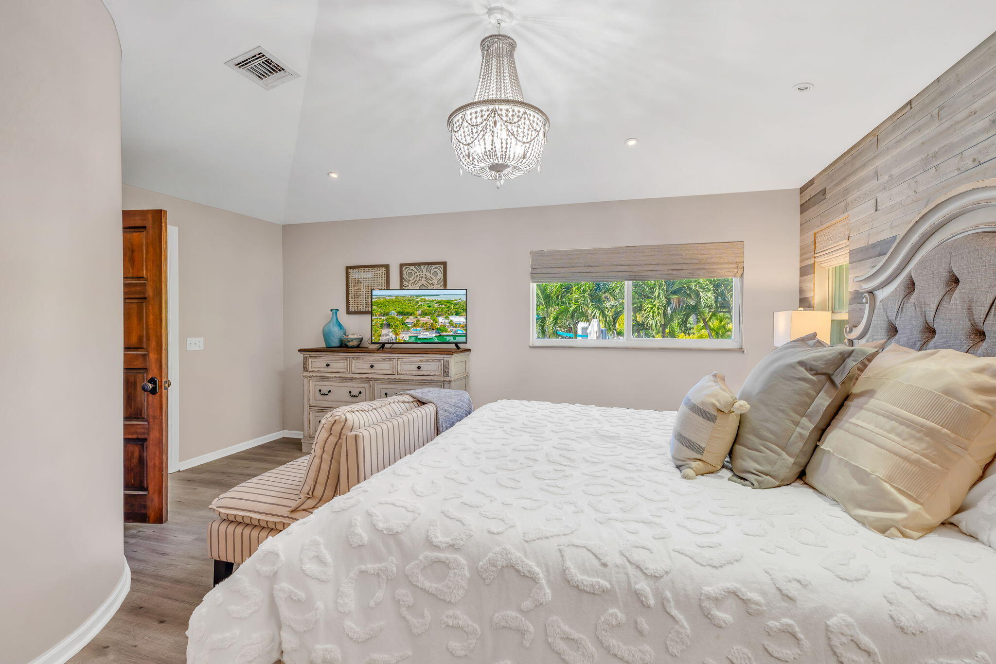 56 Colson Drive Cudjoe, FL 33042 - Photo 12 of 50 a bedroom with a bed and a chandelier