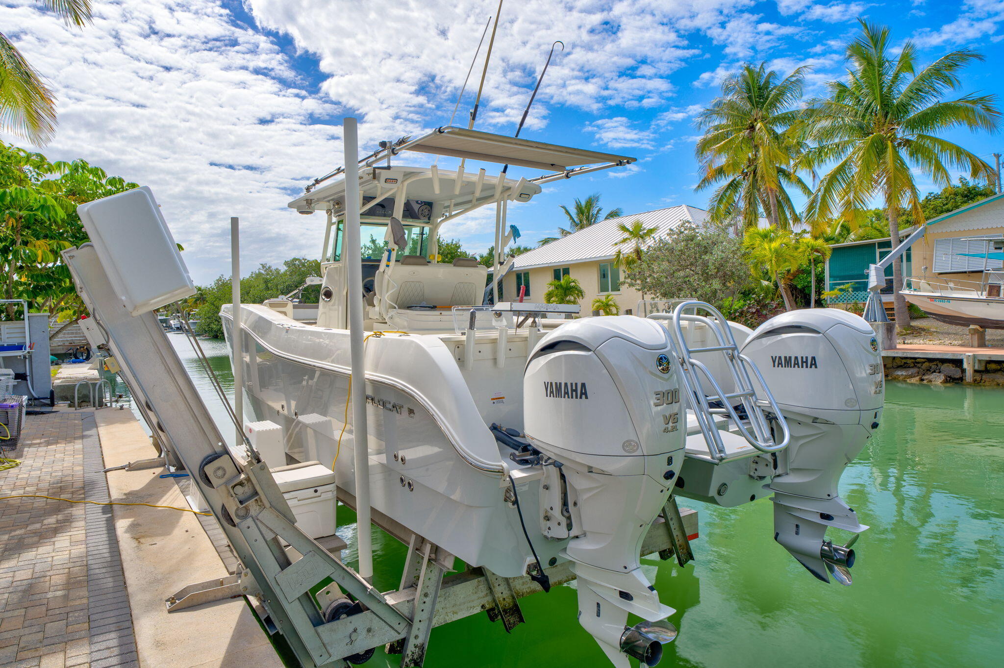 56 Colson Drive Cudjoe, FL 33042 - Photo 29 of 50 a roof deck with table and chairs under an umbrella with a barbeque