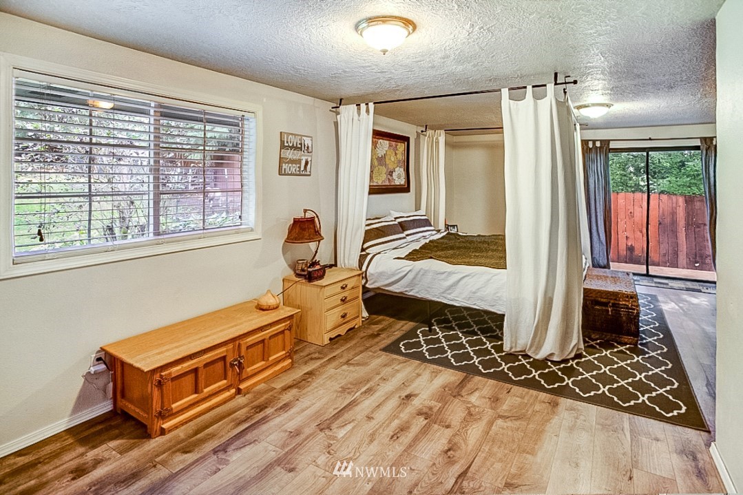 923 Newberg Road Snohomish, WA 98290 - Photo 8 of 22 a bedroom with a bed and wooden floor