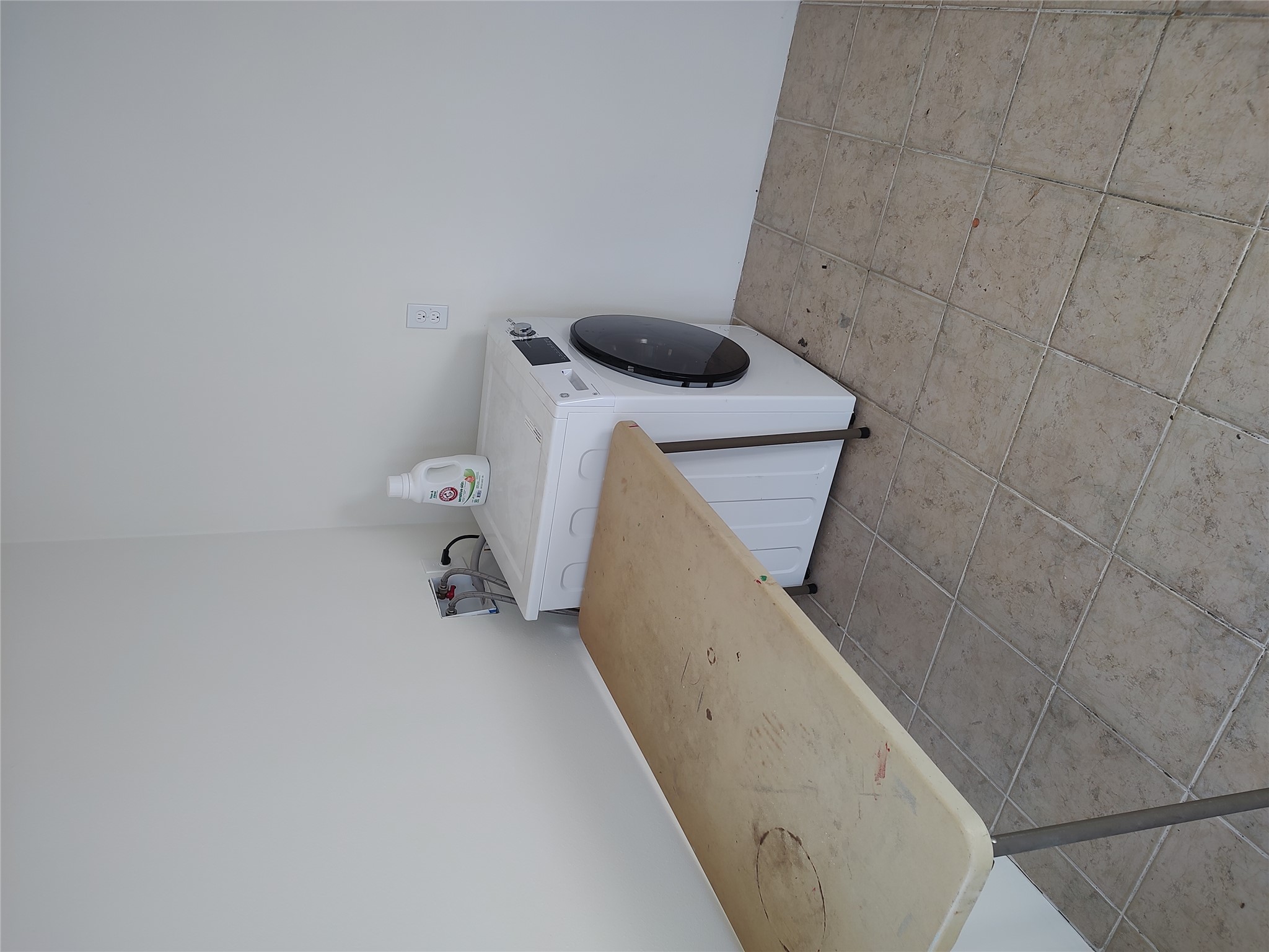 2102 Yellow Jacket Lane, Unit A Austin, TX 78741 - Photo 15 of 15 Laundry area with washer / clothes dryer and light tile patterned floors
