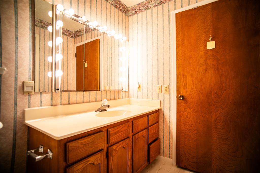 8312 Llano Avenue Benbrook, TX 76116 - Photo 14 of 40 a bathroom with a sink and a mirror