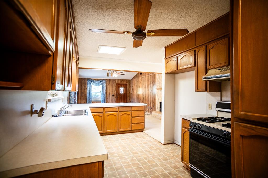 8312 Llano Avenue Benbrook, TX 76116 - Photo 17 of 40 a kitchen with stainless steel appliances granite countertop a sink stove and refrigerator