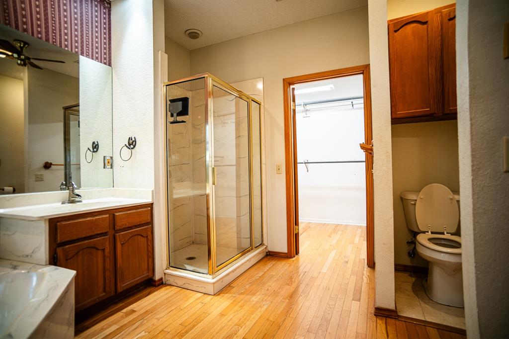 8312 Llano Avenue Benbrook, TX 76116 - Photo 26 of 40 a bathroom with a sink a toilet and shower