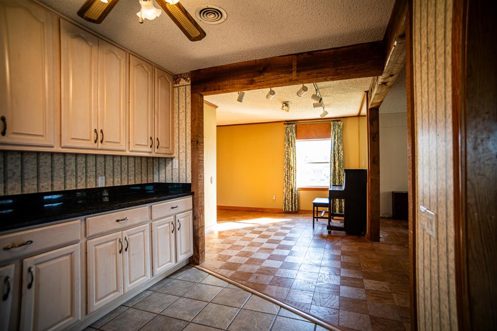 8312 Llano Avenue Benbrook, TX 76116 - Photo 35 of 40 a kitchen with granite countertop a sink and cabinets