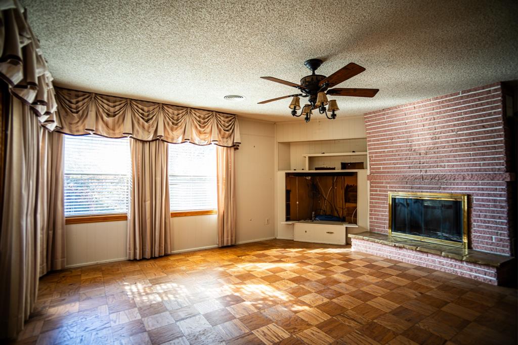 8312 Llano Avenue Benbrook, TX 76116 - Photo 36 of 40 a view of an empty room with a fireplace and a window