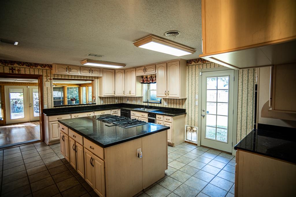 8312 Llano Avenue Benbrook, TX 76116 - Photo 38 of 40 a kitchen with stainless steel appliances granite countertop a sink and a stove