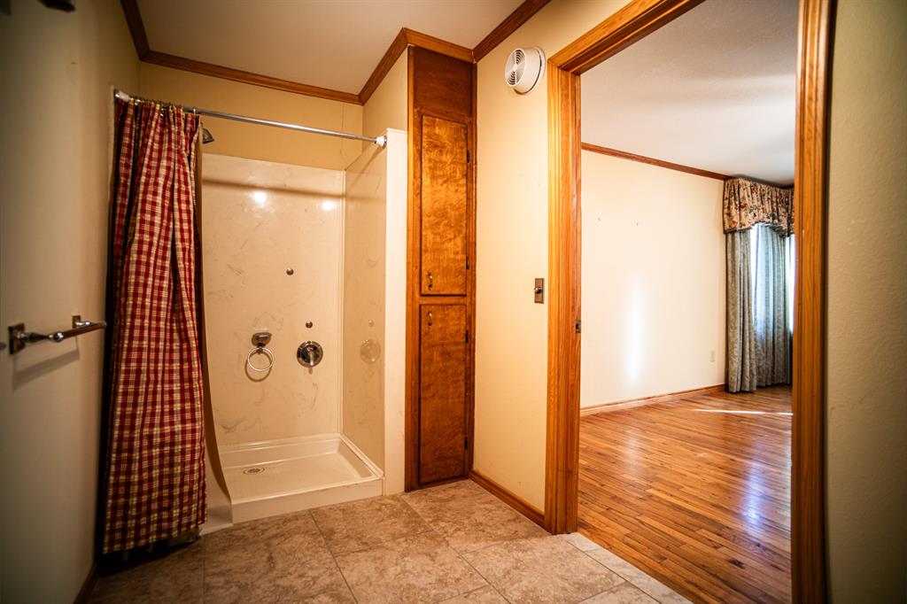 8312 Llano Avenue Benbrook, TX 76116 - Photo 40 of 40 an empty room with wooden floor and door