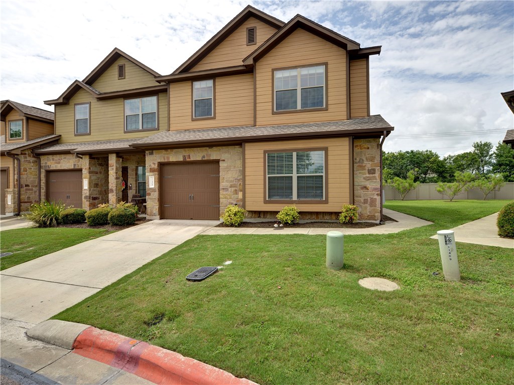 a view of a house with a yard patio and a fire pit