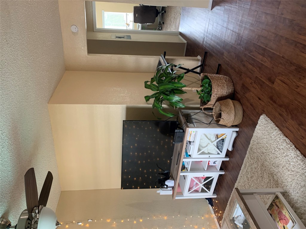 2401 Manor Road, Unit 218 Austin, TX 78722 - Photo 2 of 8 a living room with furniture and a potted plant