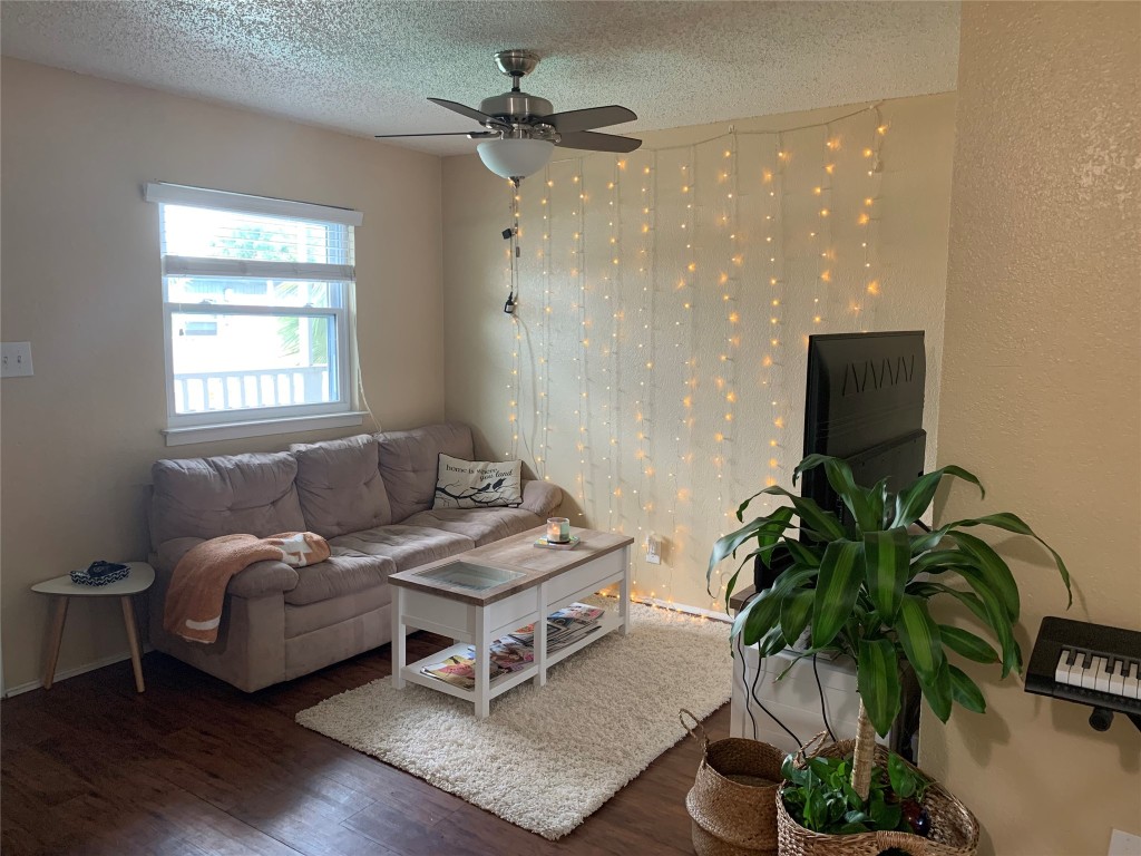 2401 Manor Road, Unit 218 Austin, TX 78722 - Photo 3 of 8 a living room with furniture and a potted plant