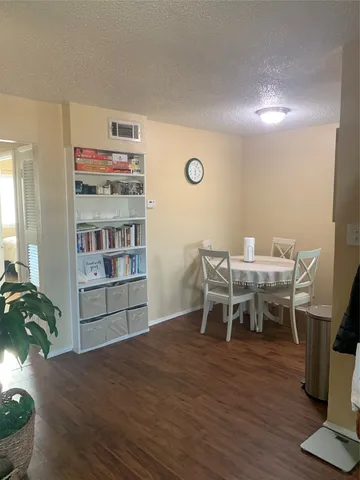 a dining room with a wooden floor and breakfast area