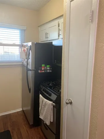 a kitchen with appliances and a refrigerator