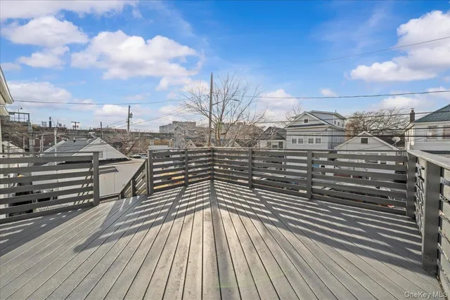 a view of a balcony with wooden floor
