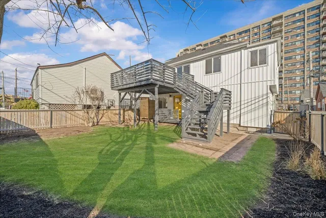 a view of a house with backyard and a patio