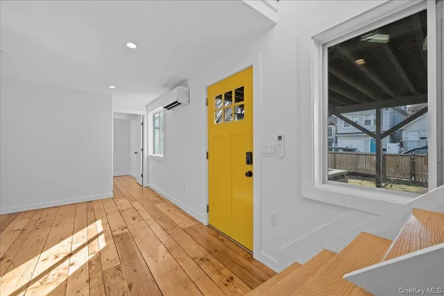 a view of an entryway with wooden floor