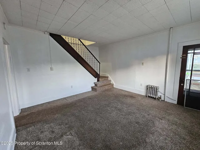 a view of an empty room with stairs