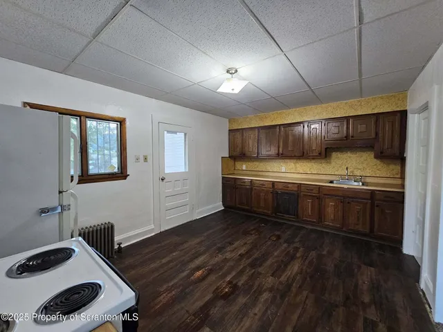 a kitchen with stainless steel appliances granite countertop a sink stove and cabinets
