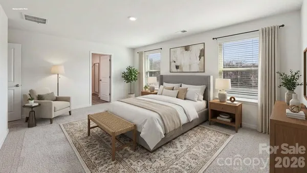 a bedroom with a large bed and a window