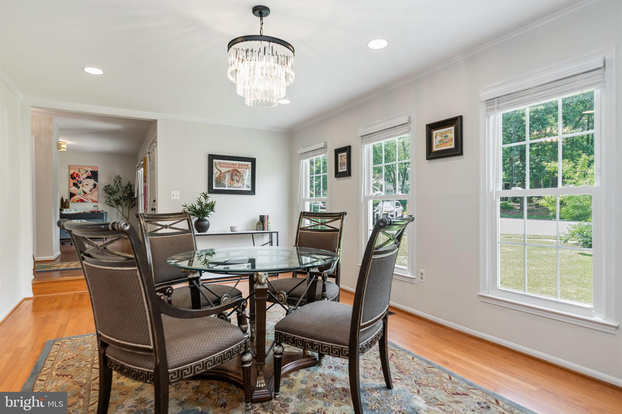 7603 Modisto Lane Springfield, VA 22153 - Photo 7 of 57 a view of a dining room with furniture window and wooden floor