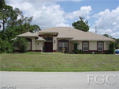 9167 Henry Road Fort Myers, FL 33967 - Photo 1 of 10 a front view of a house with a garden