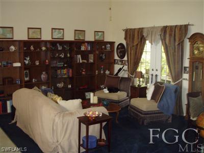9167 Henry Road Fort Myers, FL 33967 - Photo 2 of 10 a living room with furniture and a floor to ceiling window